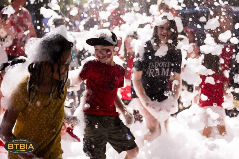 A bunch of kids having fun during one of FoamGuy's after-fire parties!