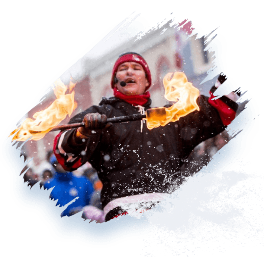 FireGuy holding fiery baton, the image captureing him in the middle of talking to a crowd.