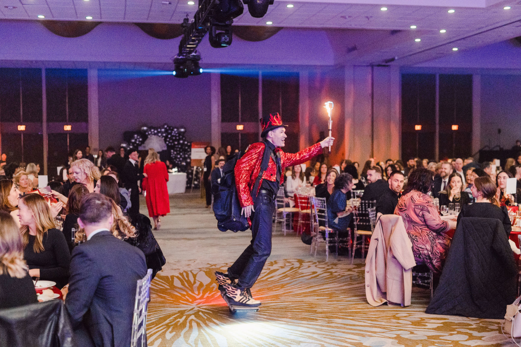 FireGuy making a grand entrance into the CMA by skateboarding in with a single torch lit!